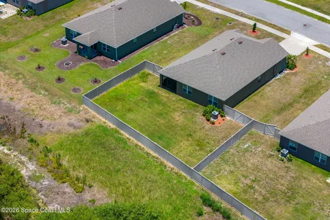 an aerial view of residential house with outdoor space and swimming pool