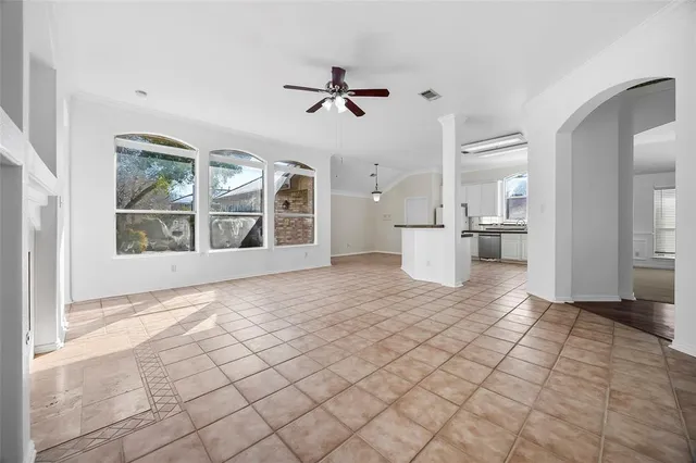 a view of a livingroom with wooden floor and a kitchen