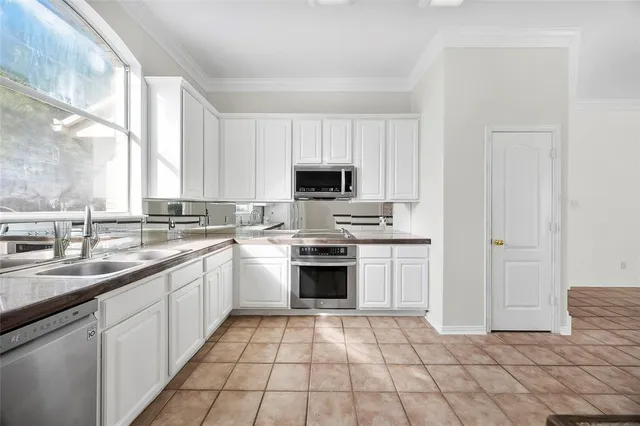a kitchen with a sink stove and microwave