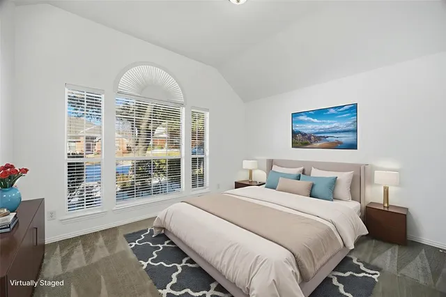 a bedroom with a large bed and a window