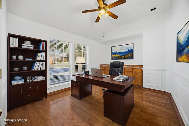 a view of a workspace with furniture and a window