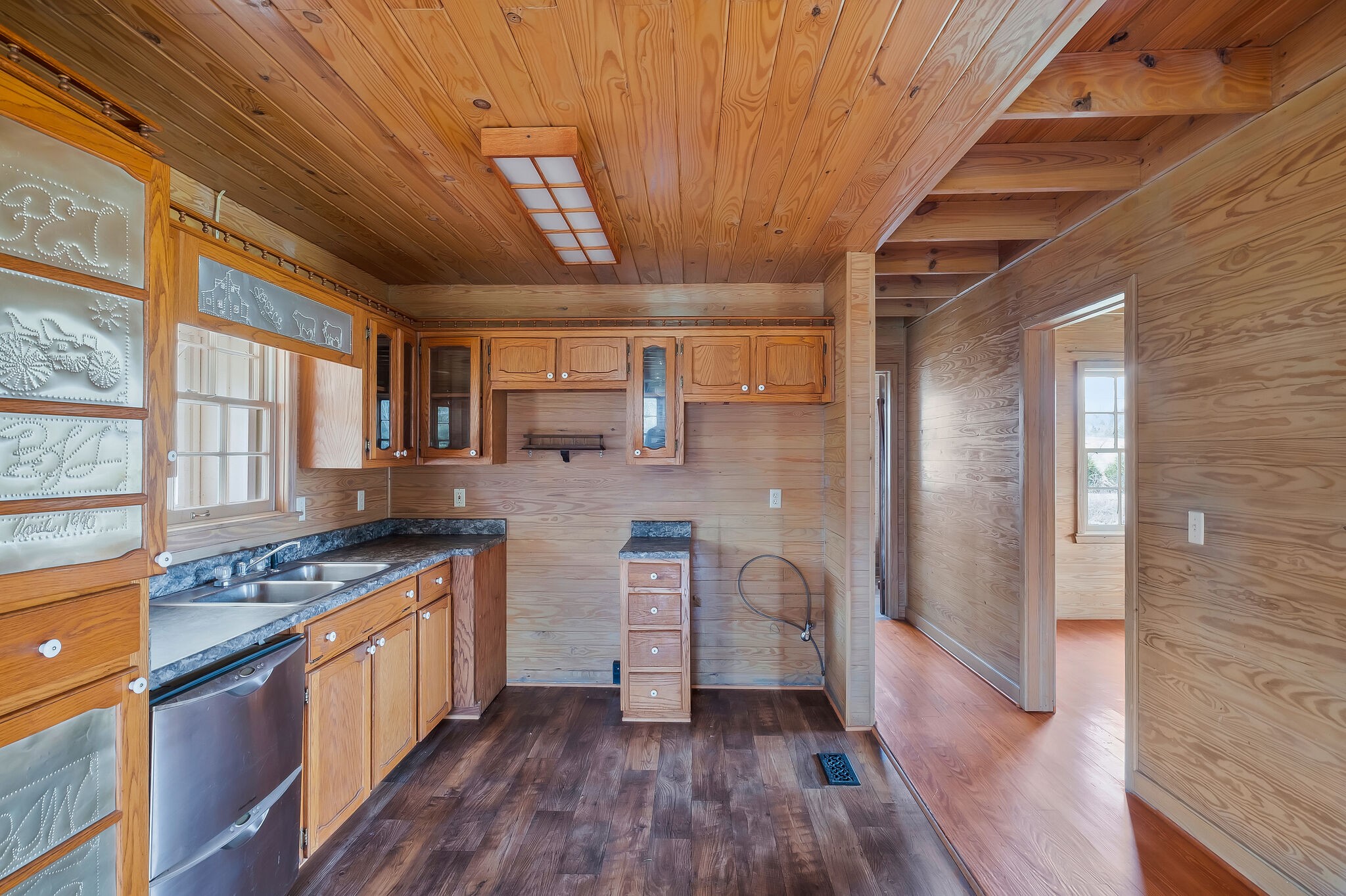198 Treece Lane Waynesboro, TN 38485 - Photo 12 of 69 a kitchen with stainless steel appliances granite countertop a stove top oven a sink dishwasher a dining table and chairs with wooden floor