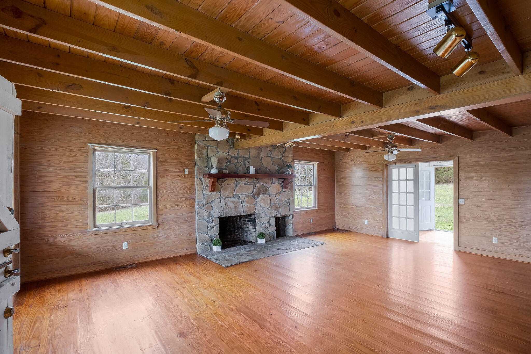 198 Treece Lane Waynesboro, TN 38485 - Photo 7 of 69 a view of an empty room with wooden floor fireplace and a window