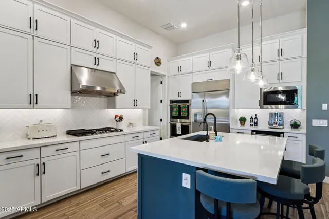 a kitchen with white cabinets and white appliances