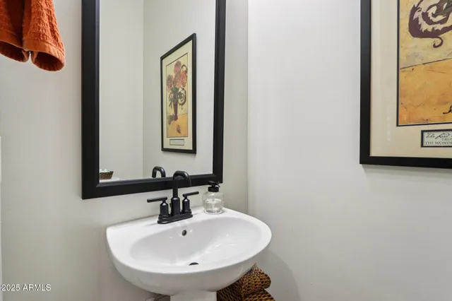 a kitchen with a sink a counter space appliances and cabinets