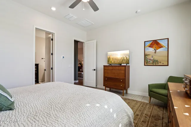 a bed sitting in a bedroom and painting on the wall