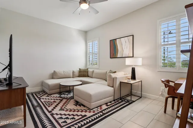 a living room with furniture and a lamp