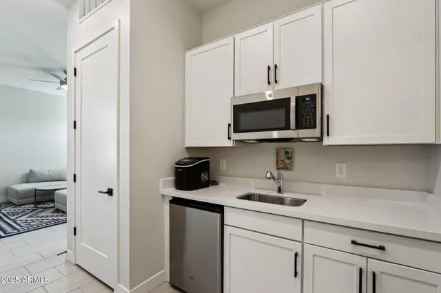 a kitchen with a sink stainless steel appliances and cabinets