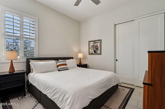 a bedroom with a bed and a night stand