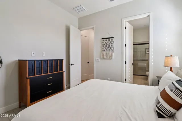 a bedroom with a bed and a dresser