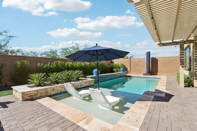 a view of a patio with couches under an umbrella