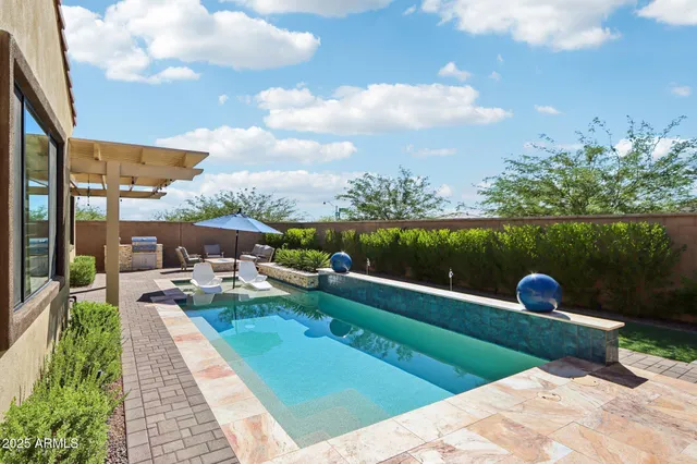 a front view of a house with a garden and balcony