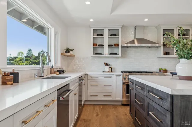 a kitchen with a sink stove and cabinets