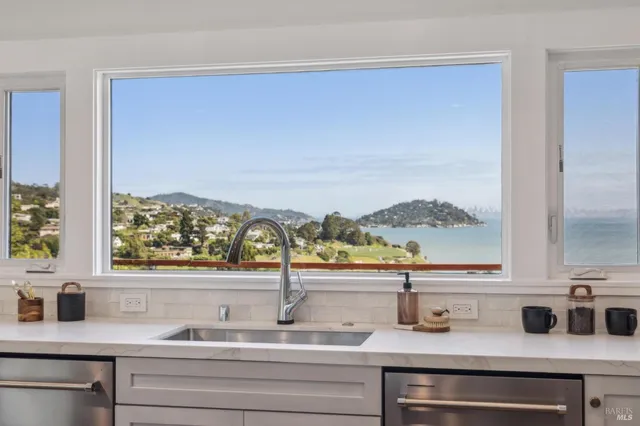 a view of a kitchen counter top a stove and a window