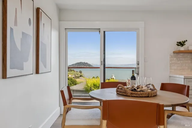 a view of a workspace with furniture and window