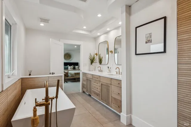 a large bathroom with a sink and mirror
