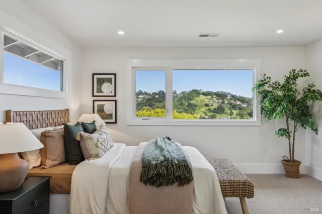 a bed room with a bed and a potted plant