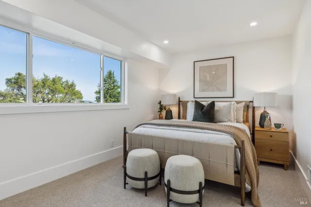 a bedroom with a bed and a painting on the wall