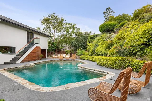 a view of a swimming pool with lounge chair