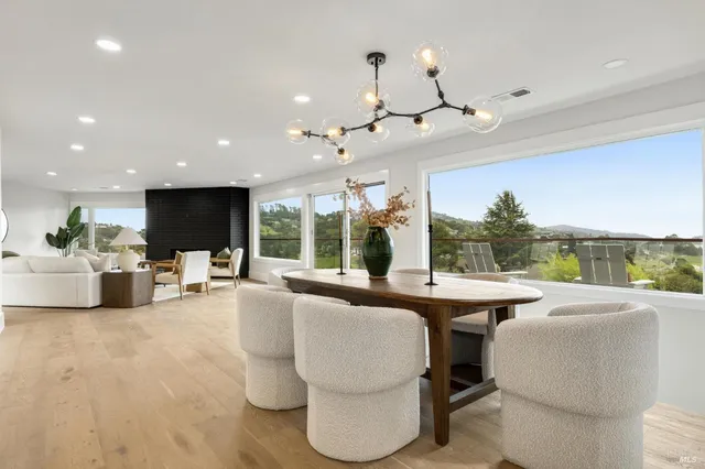 a living room with fireplace furniture and a large window