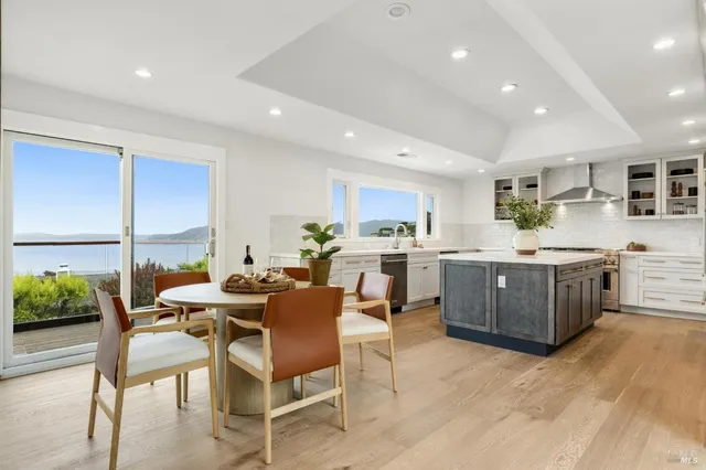 a large kitchen with a table and chairs