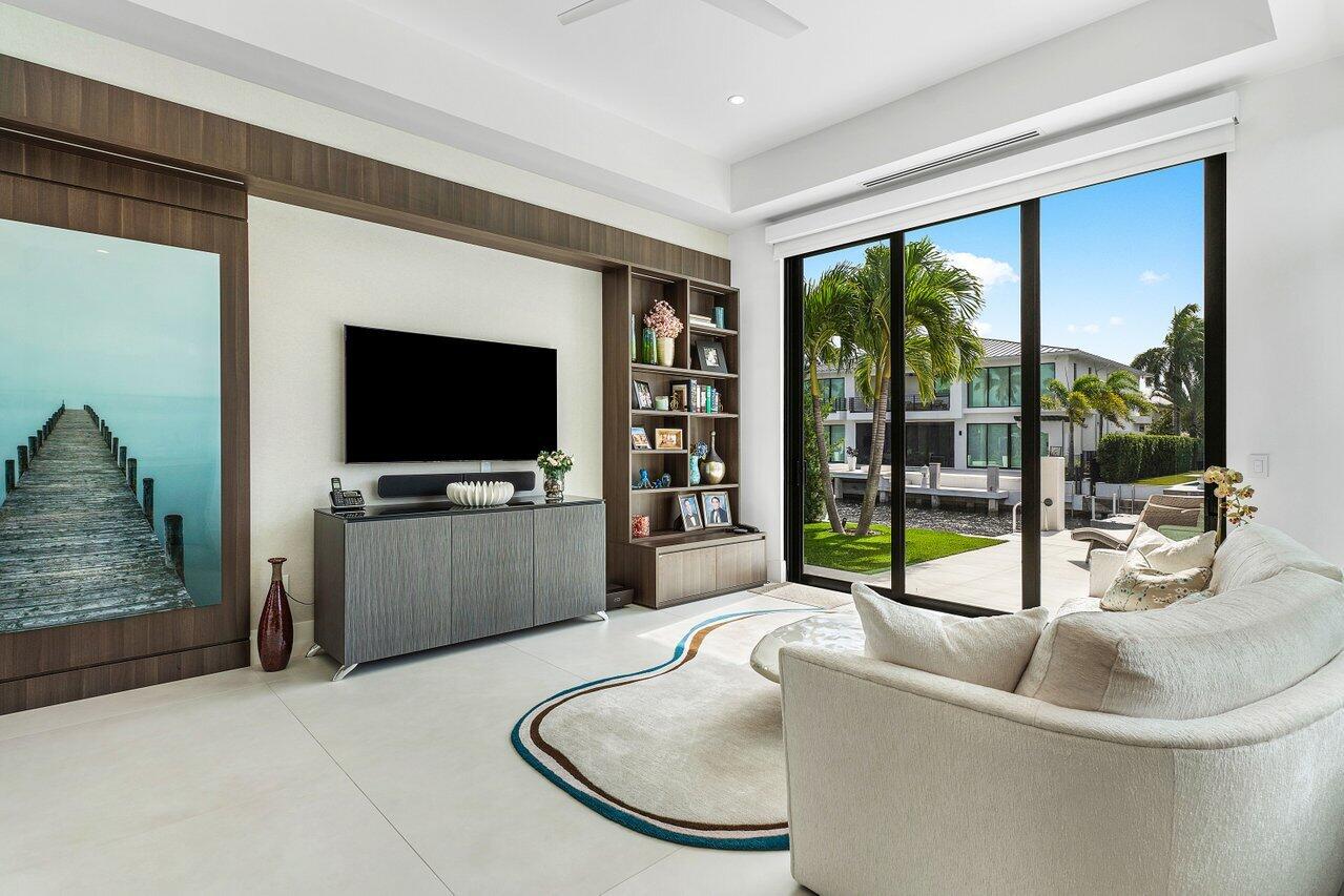 680 Marine Drive Boca Raton, FL 33431 - Photo 11 of 42 a living room with a couch a flat screen tv and a large window