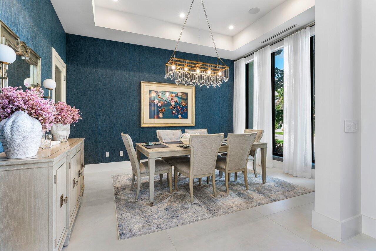 680 Marine Drive Boca Raton, FL 33431 - Photo 15 of 42 a dining room with furniture a chandelier and window