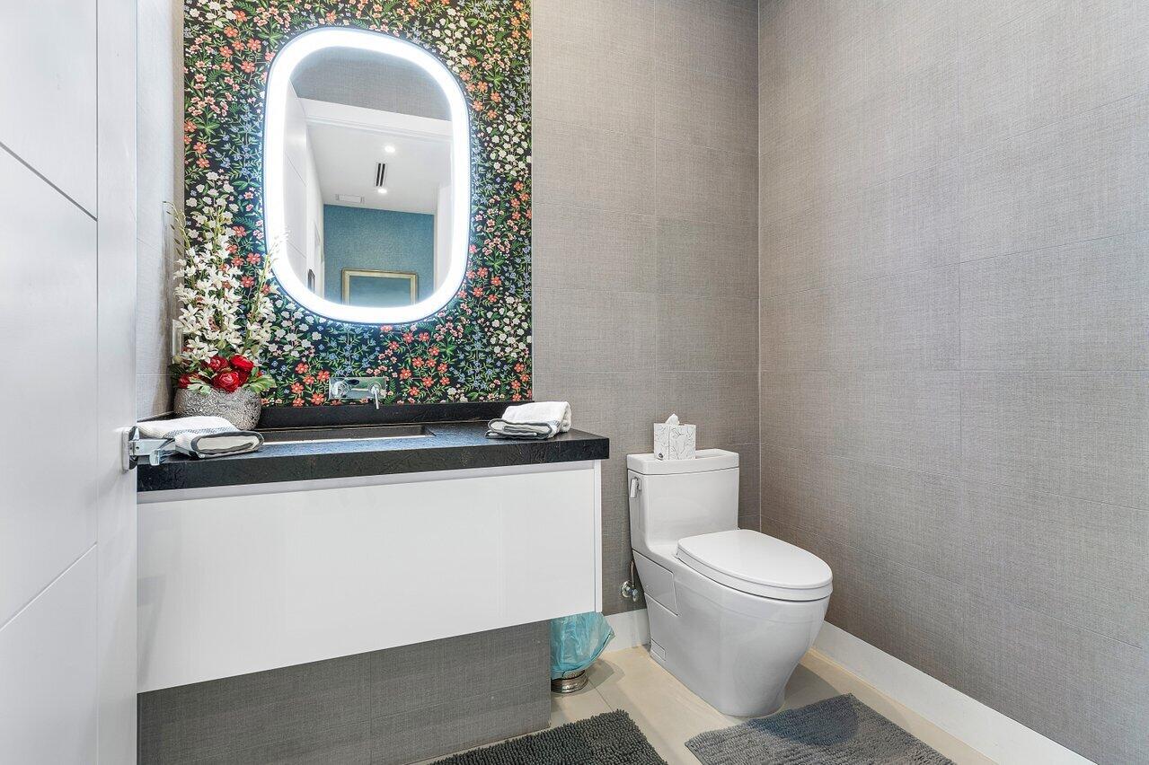 680 Marine Drive Boca Raton, FL 33431 - Photo 22 of 42 a bathroom with a toilet sink mirror and vanity