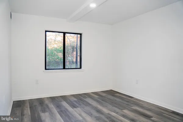 a view of walk in closet with wooden floor