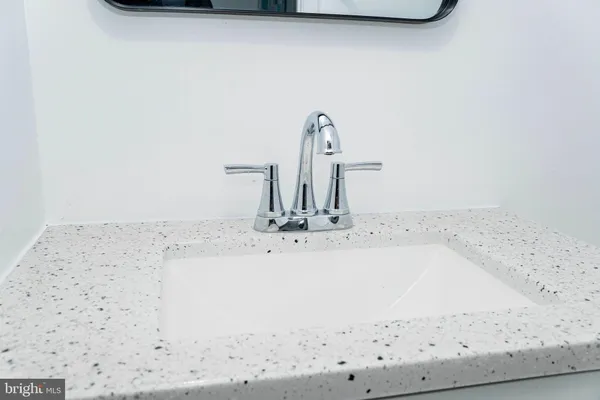 a bathroom with a sink vanity and a mirror