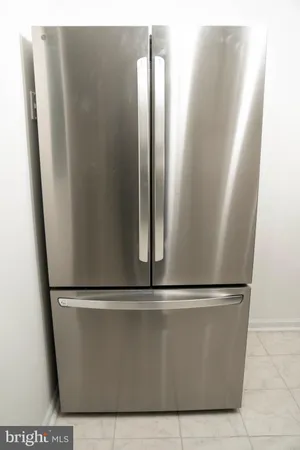 a kitchen with granite countertop white cabinets and a stove