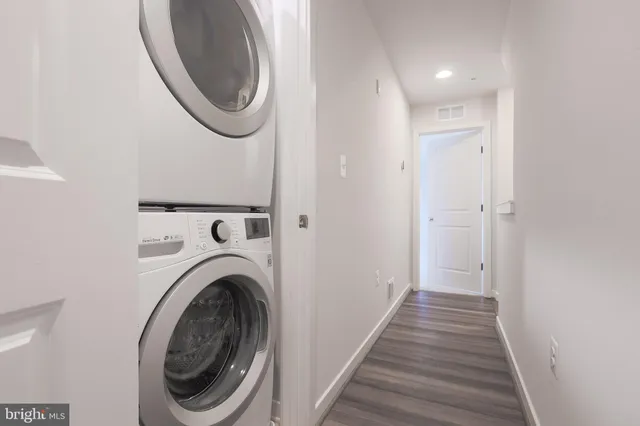 a view of a hallway with washer and dryer