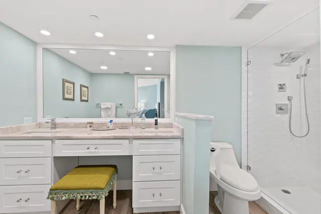 a spacious bathroom with a granite countertop sink a toilet and a mirror