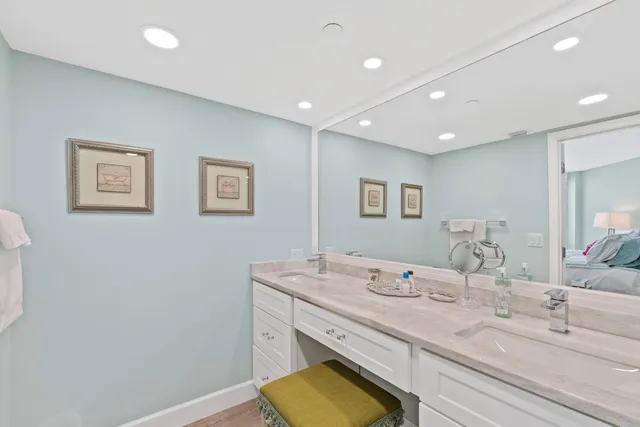 a bathroom with a granite countertop sink a large mirror and vanity