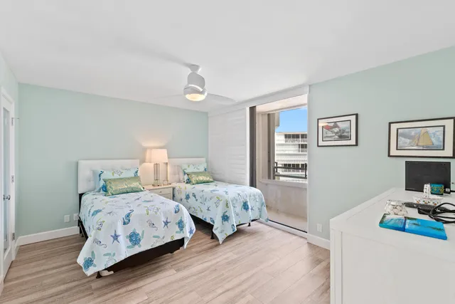 a bedroom with two beds and a table