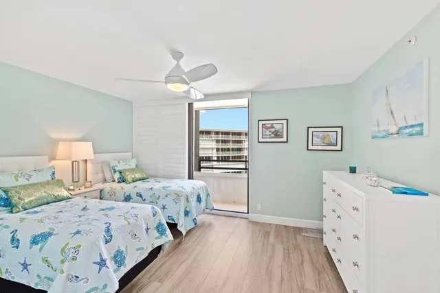 a bedroom with two beds and a window