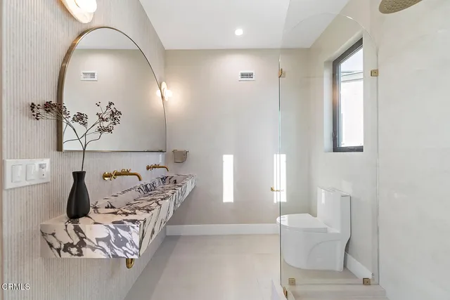 a living room with furniture a flat screen tv and floor to ceiling window