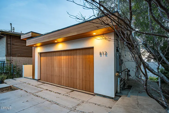 a view of a house with a door and wooden walls