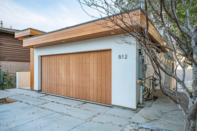 a large white kitchen with a large window