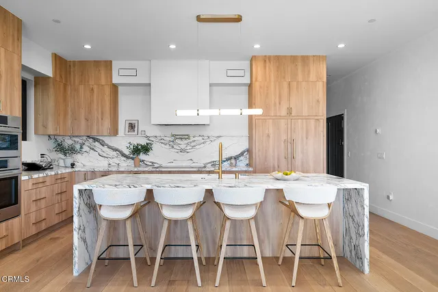 a kitchen with a table chairs and window