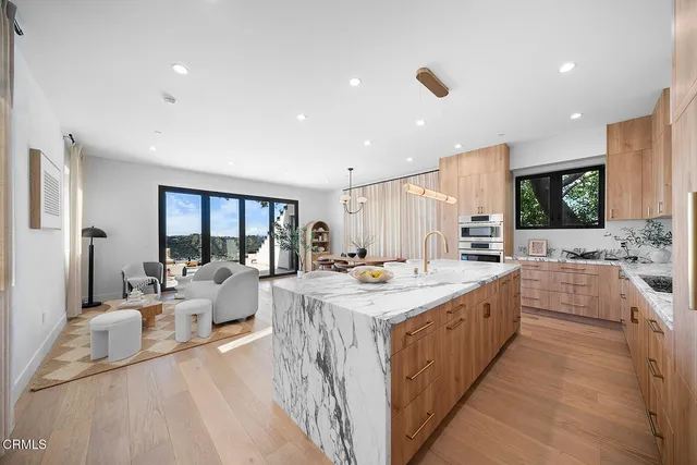 a bedroom with a large bed and a large window