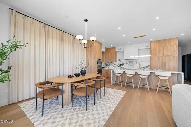 a spacious bedroom with a bed and a chandelier
