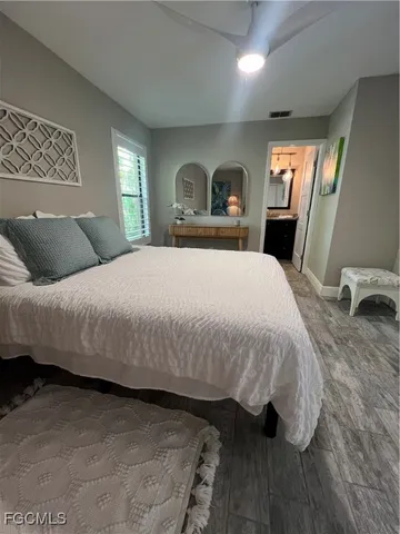 a bedroom with a bed and a large mirror