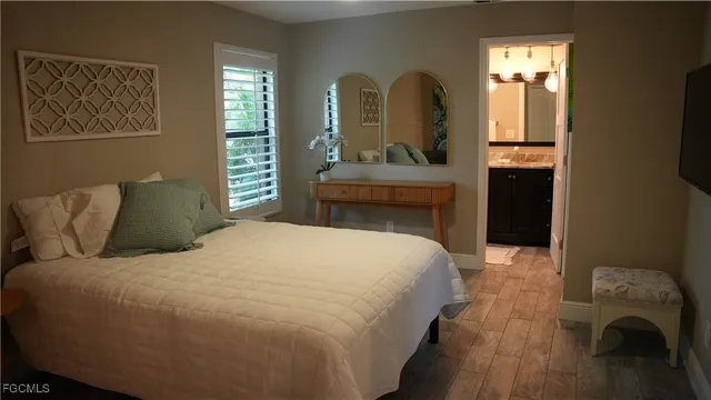 a bedroom with a bed and a mirror