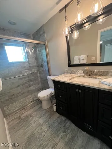a bathroom with a sink vanity mirror and toilet