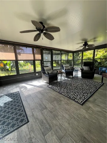 an outdoor living room with furniture and a large window