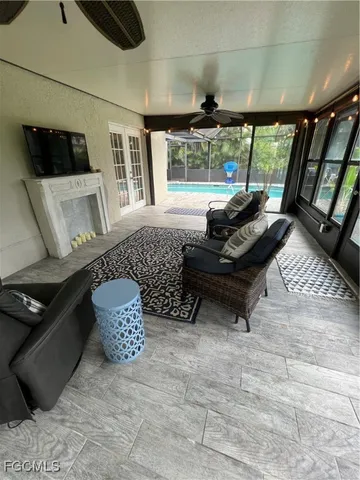 a living room with furniture and a floor to ceiling window