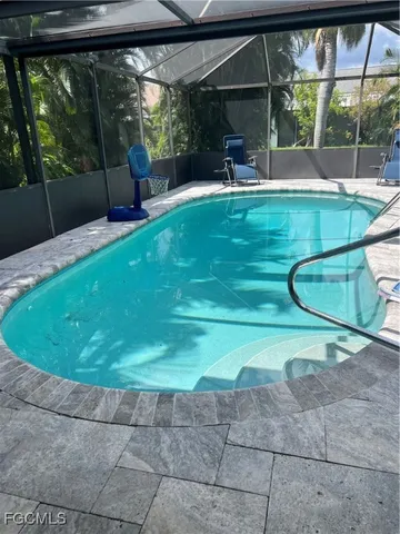 a view of house with garden and a sitting area