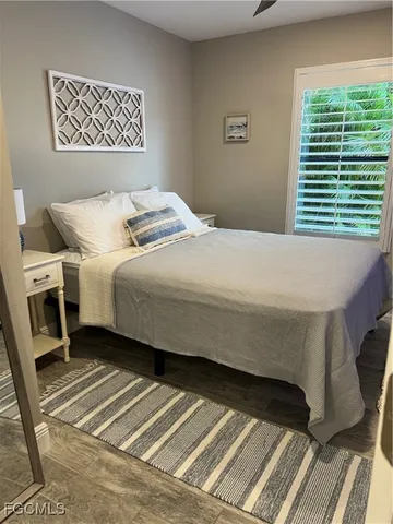 a bedroom with a bed next to a window