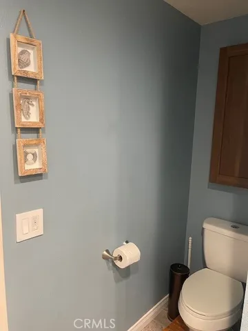 a white toilet sitting next to a bathroom sink